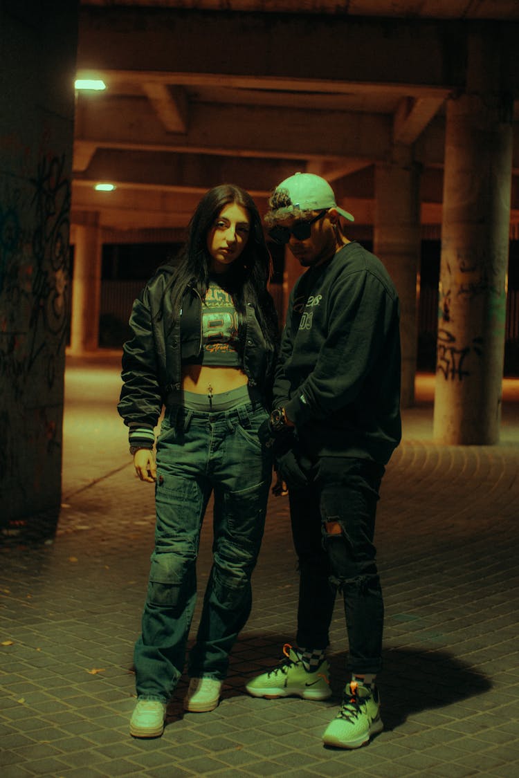 Pair Of Adolescent People Posing In Leisure Wear