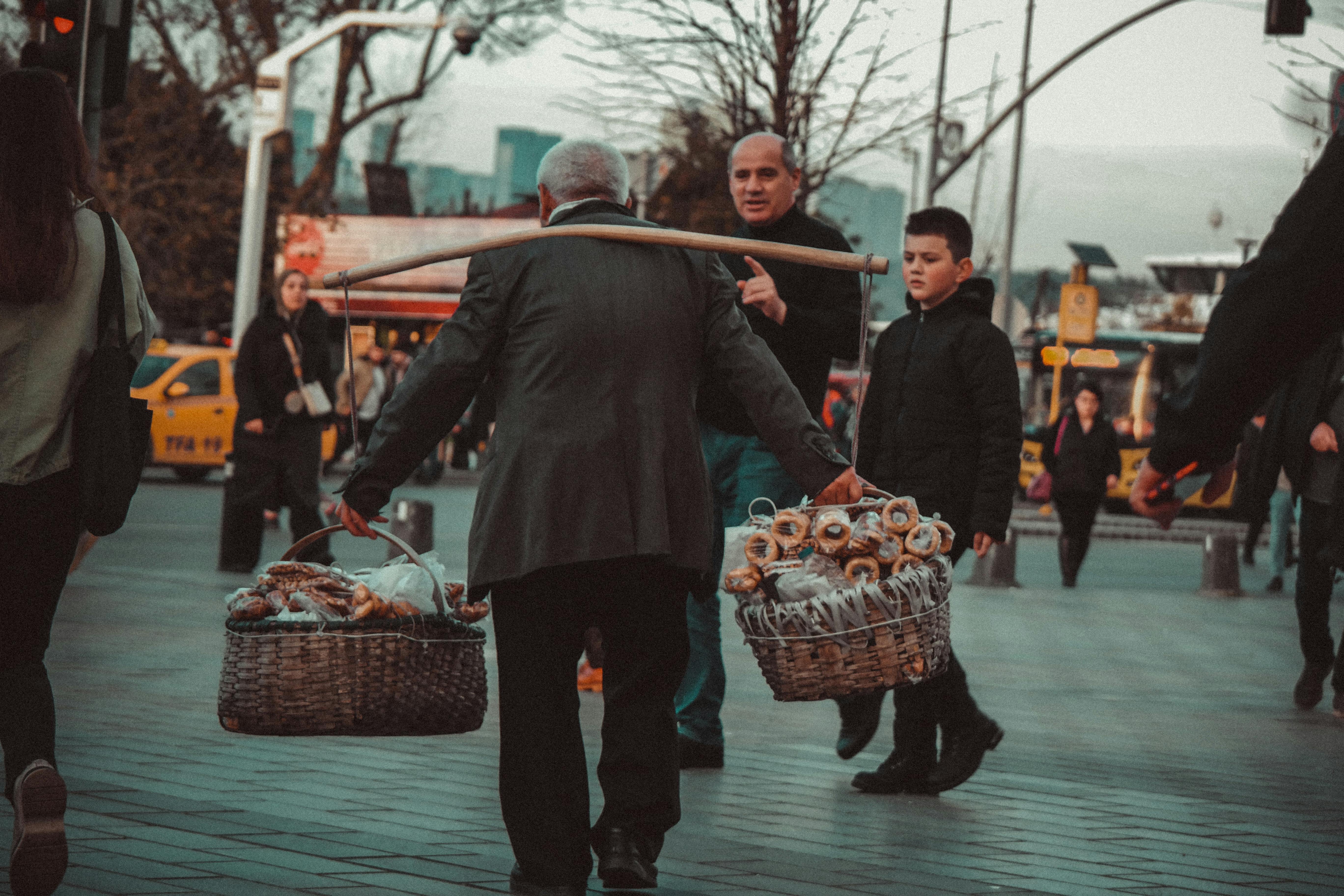 a person carrying baskets of assorted goods