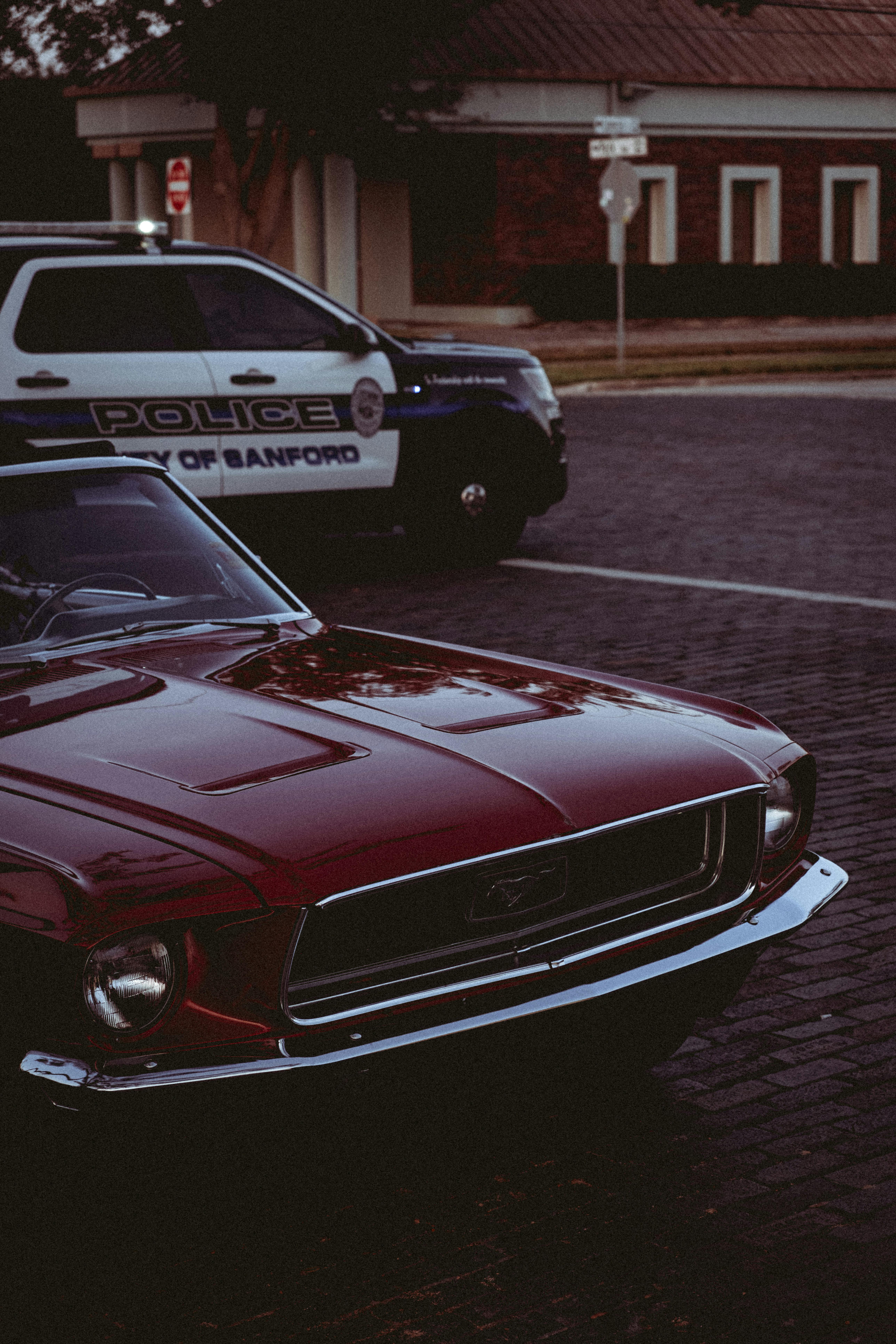 a red and white car parked on a brick road