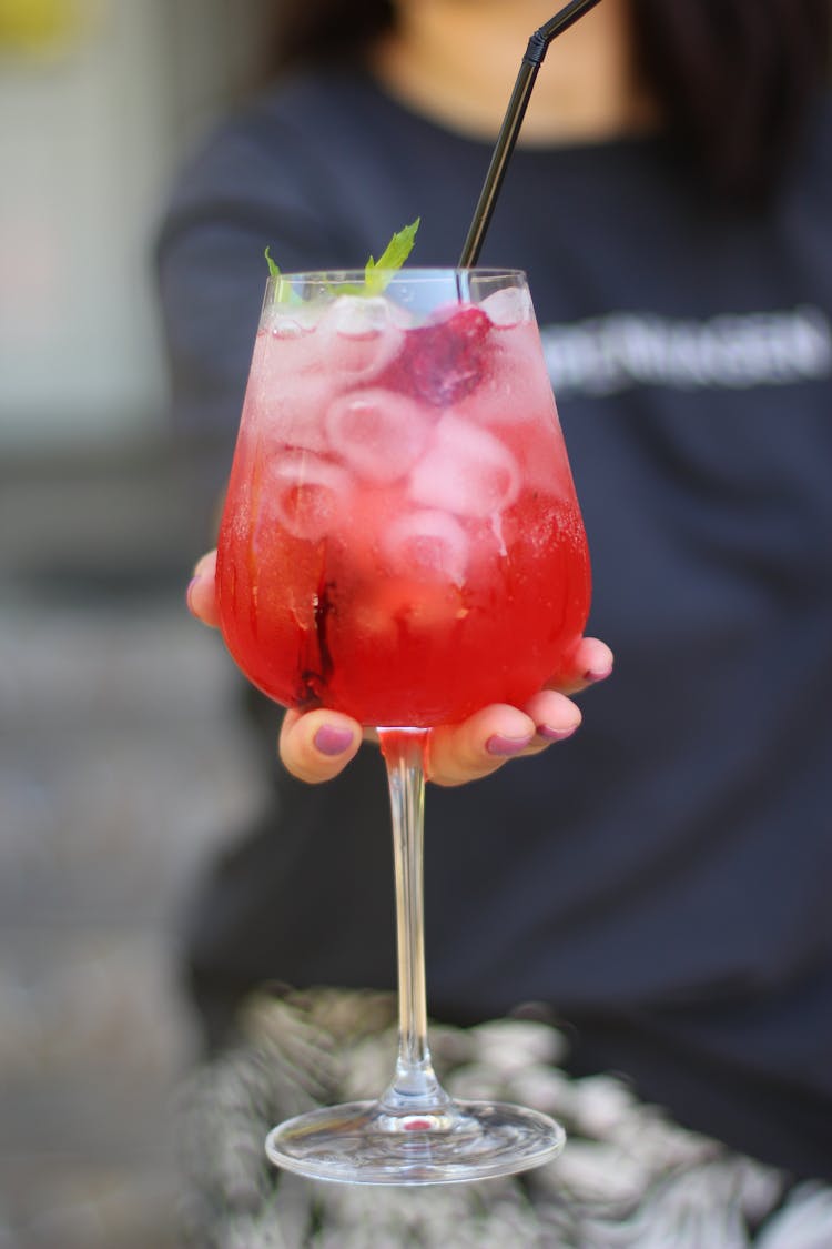 Woman Holding A Glass Of Red Icee Cocktail Drink