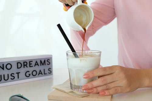 Free Person Pouring Liquid In Drinking Glass Stock Photo