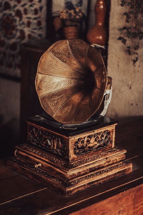 Free A vintage gramophone on a wooden table in a rustic interior setting. Stock Photo
