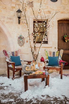 Charming outdoor winter scene with rustic furniture and decor in snowy Ürgüp, Türkiye.