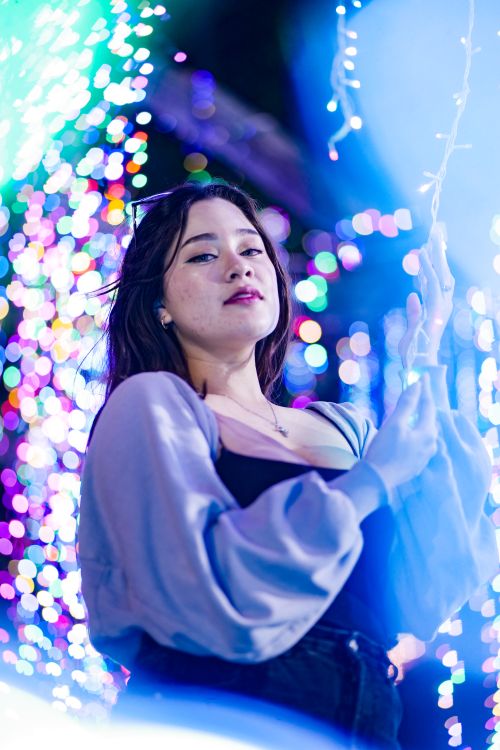 Free Elegant woman enjoying colorful night lights in Panama City, Panama. Stock Photo