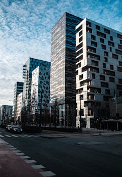 A vibrant street in Oslo showcasing modern buildings under a clear sky.