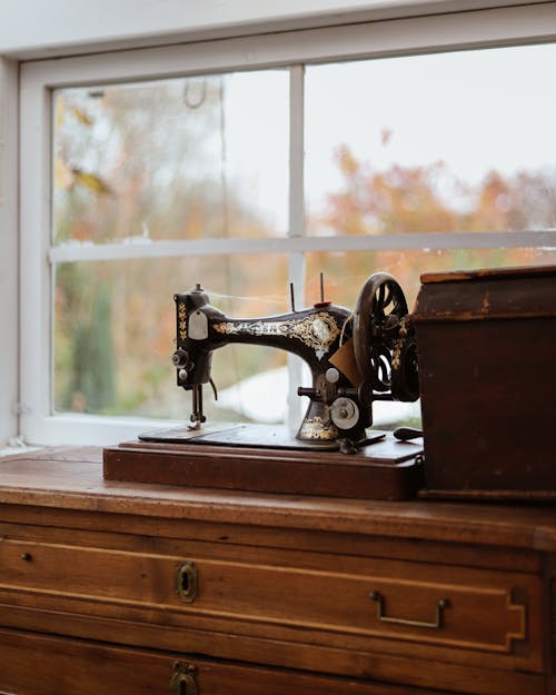 Antique Sewing Machine on Wooden Sideboard