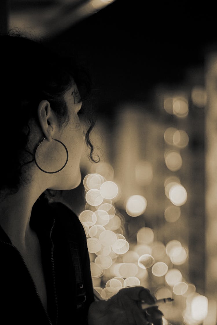 Woman With A Cigarette In Hand Looking At Lights 