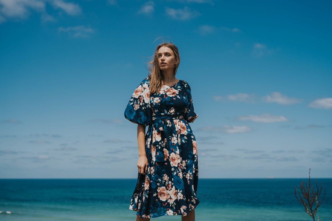 Woman in a floral wrap top with white shorts