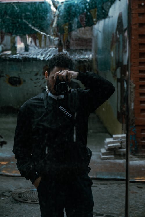 Photo of Man Holding a Dslr Camera