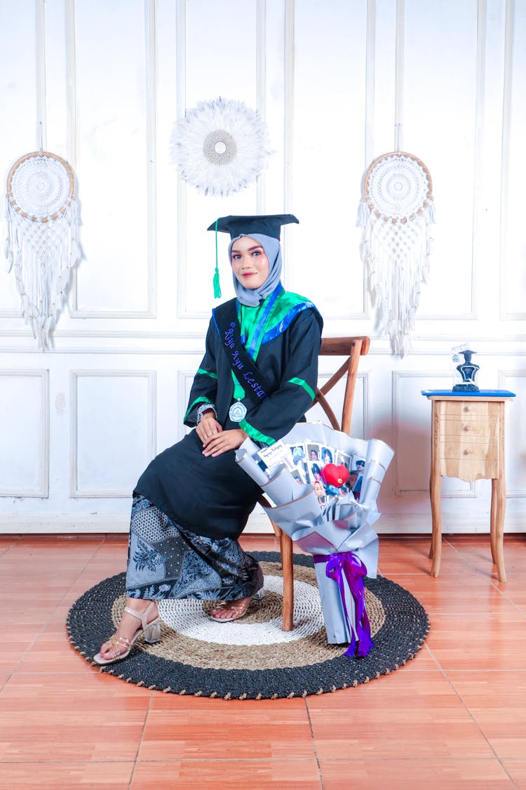 Graduate Posing Against Dreamcatchers