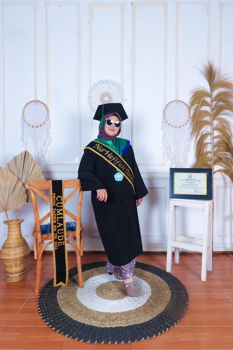 Woman Posing While Wearing An Academic Regalia 