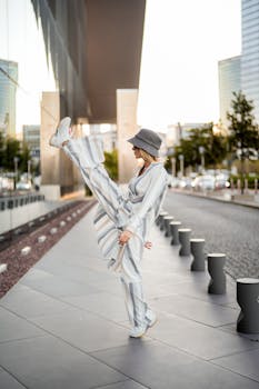 A fashionable woman poses dynamically on a modern street in Istanbul.