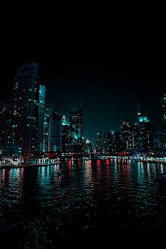 Captivating night scene of Dubai Marina with vibrant reflections on the water.
