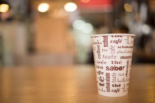 Shallow Depth of Field Photo of Disposable Cup on Brown Surface