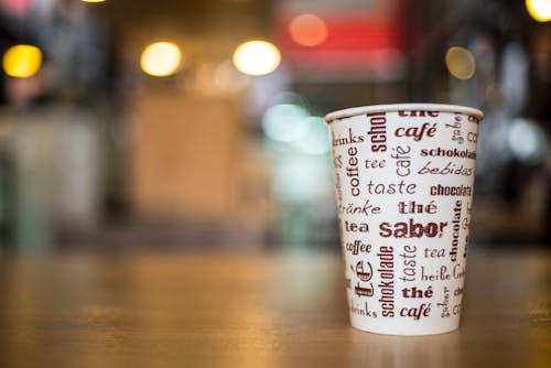Free Selective-focus Photography of White and Brown Coffee Cup on Brown Wooden Surface Stock Photo