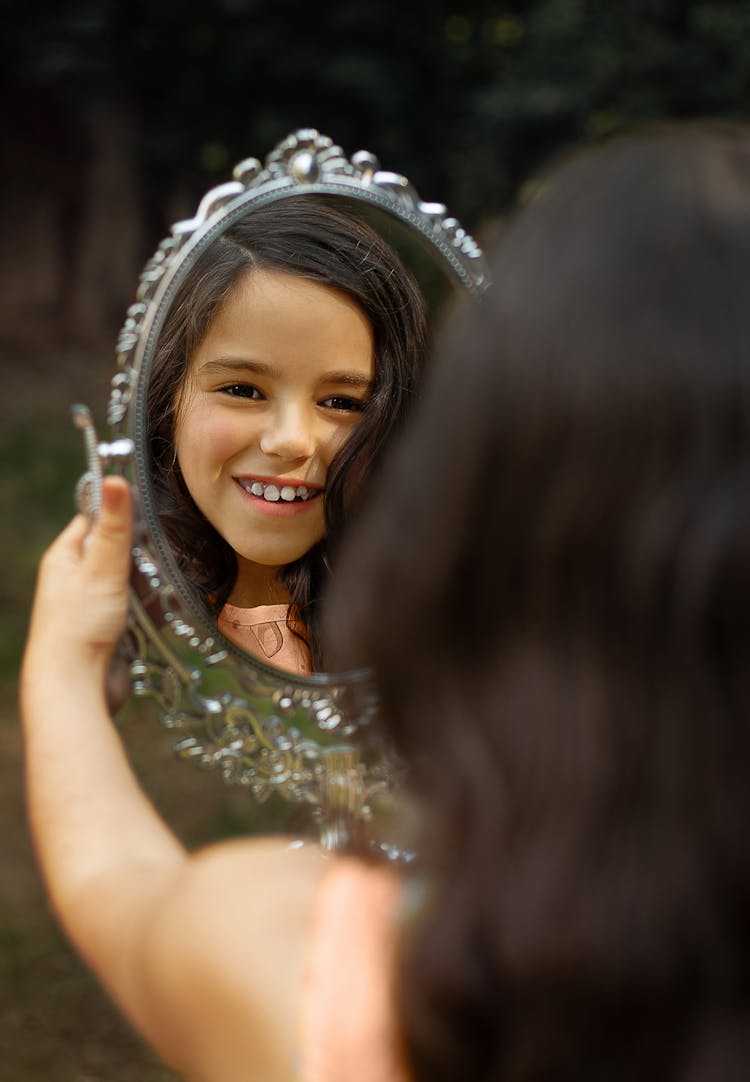 A Girl Looking At The Mirror