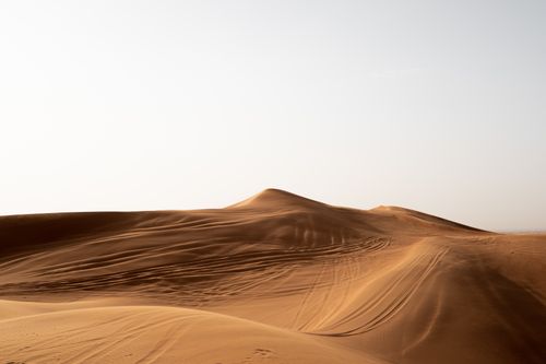 A desert landscape with sand dunes and a blue sky · Free Stock Photo