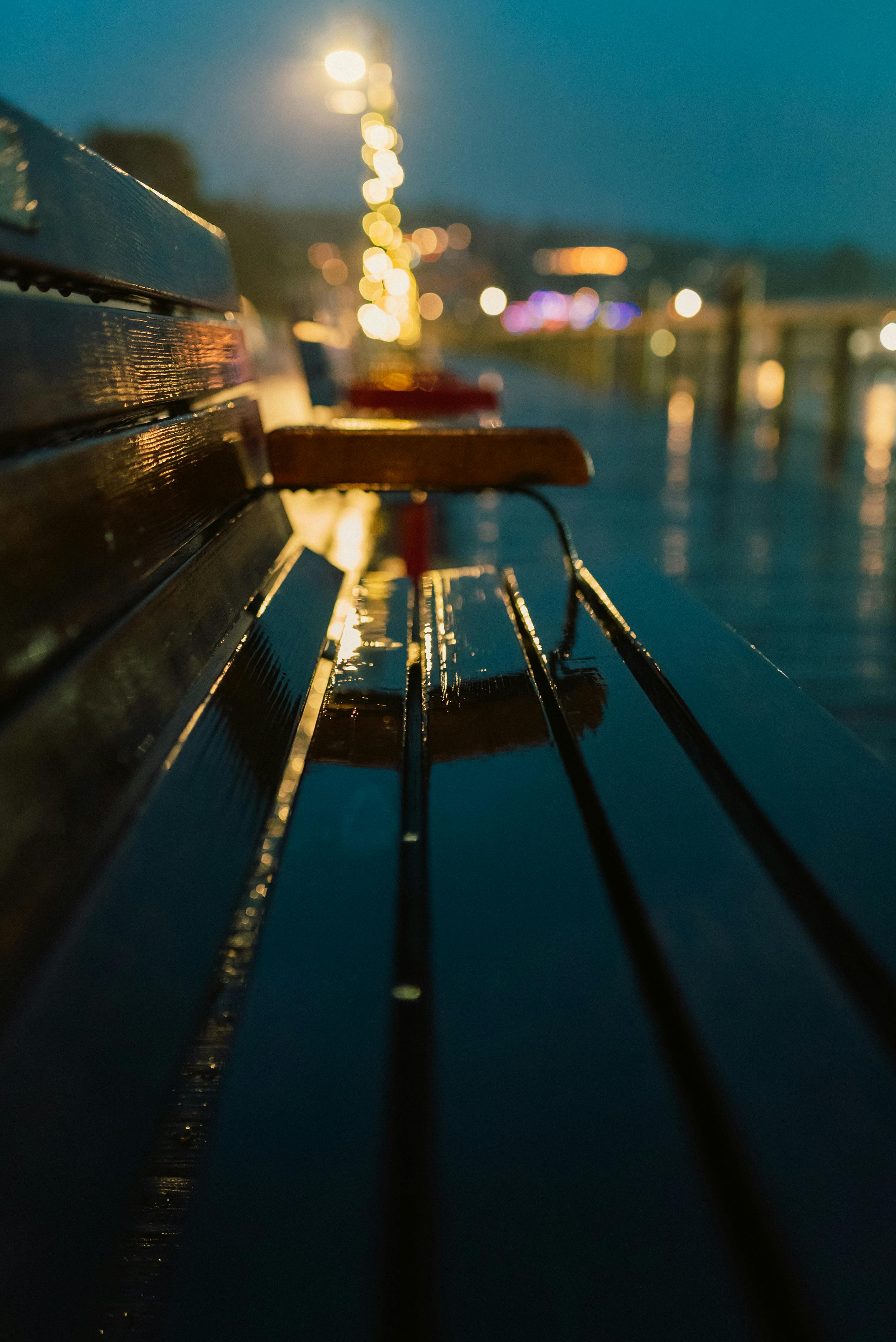 a bench with a light on it at night