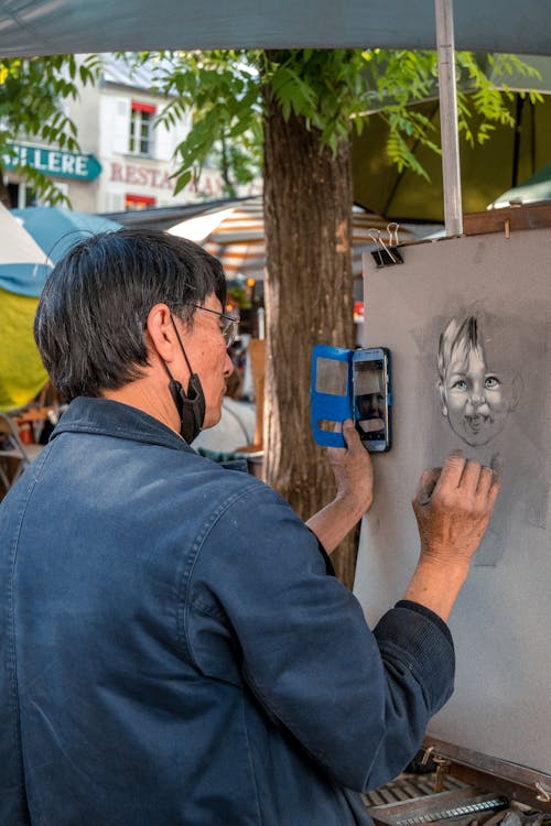 Man Drawing Face from Smartphone