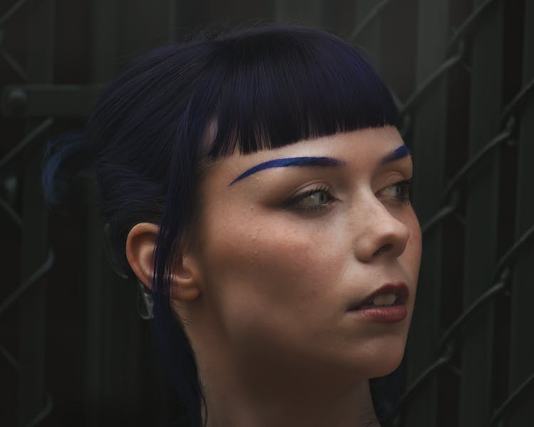 A Woman With Blue Eyebrows