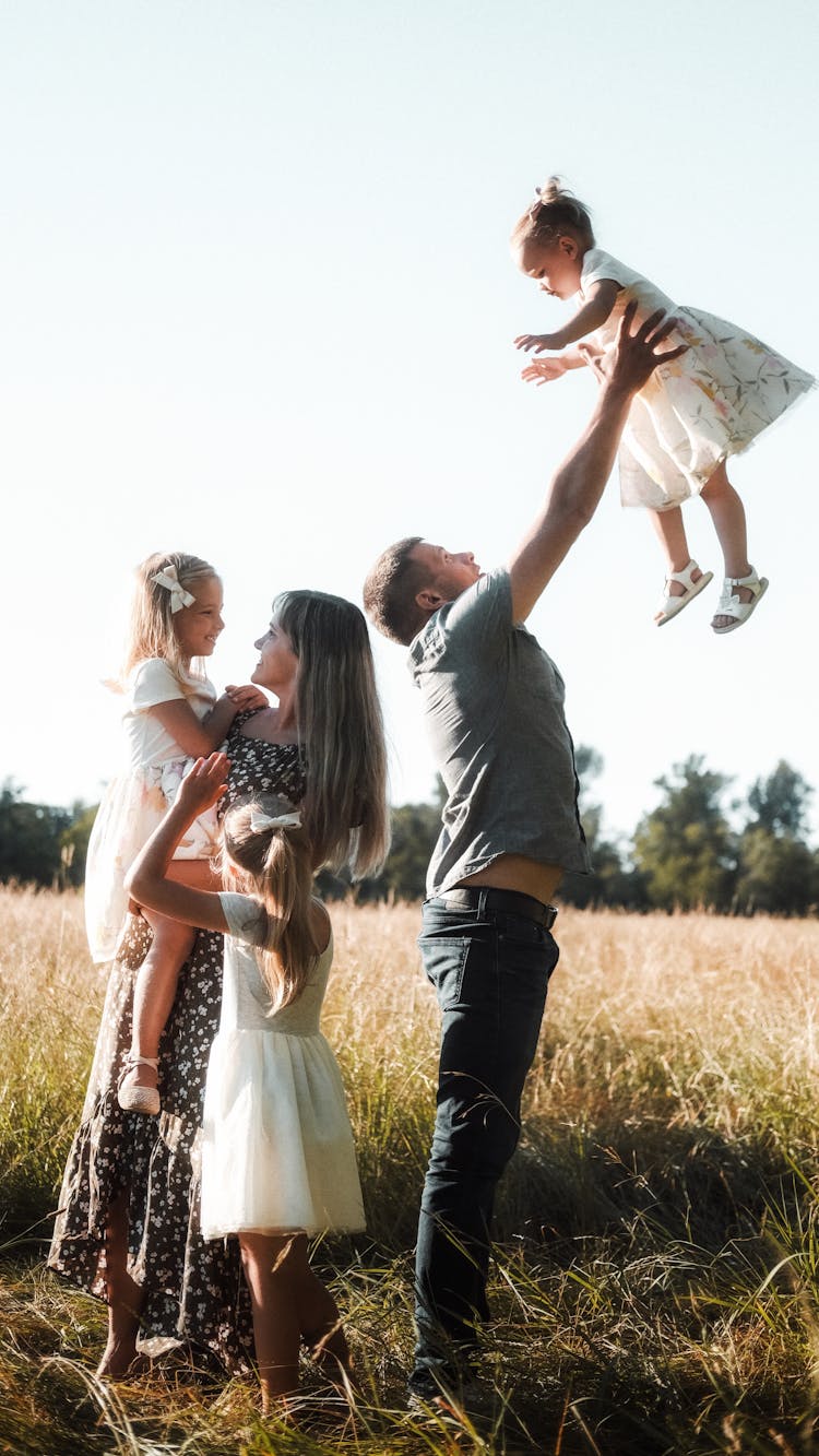 Happy Family Together On Field