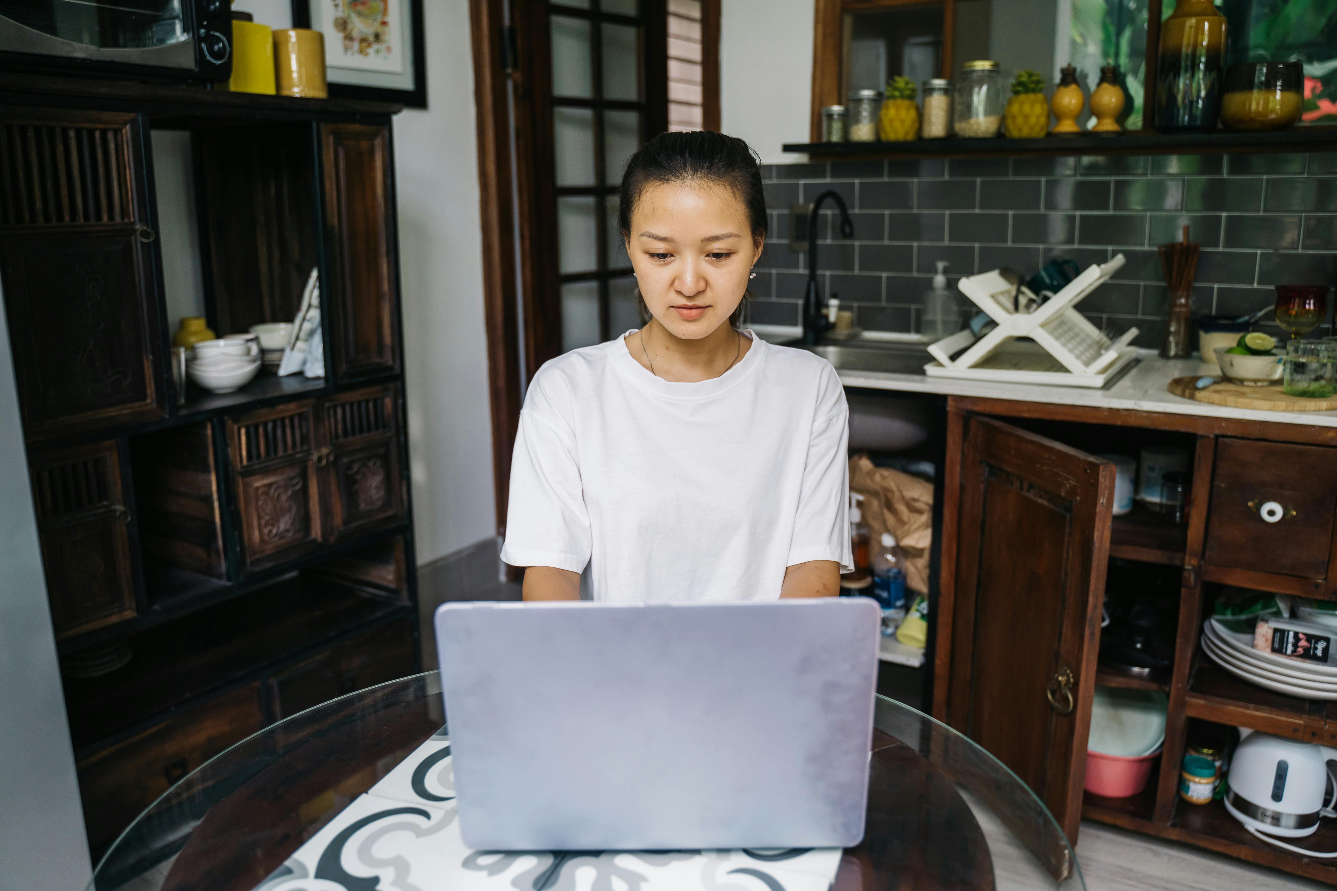 young woman using laptop in the kitchen