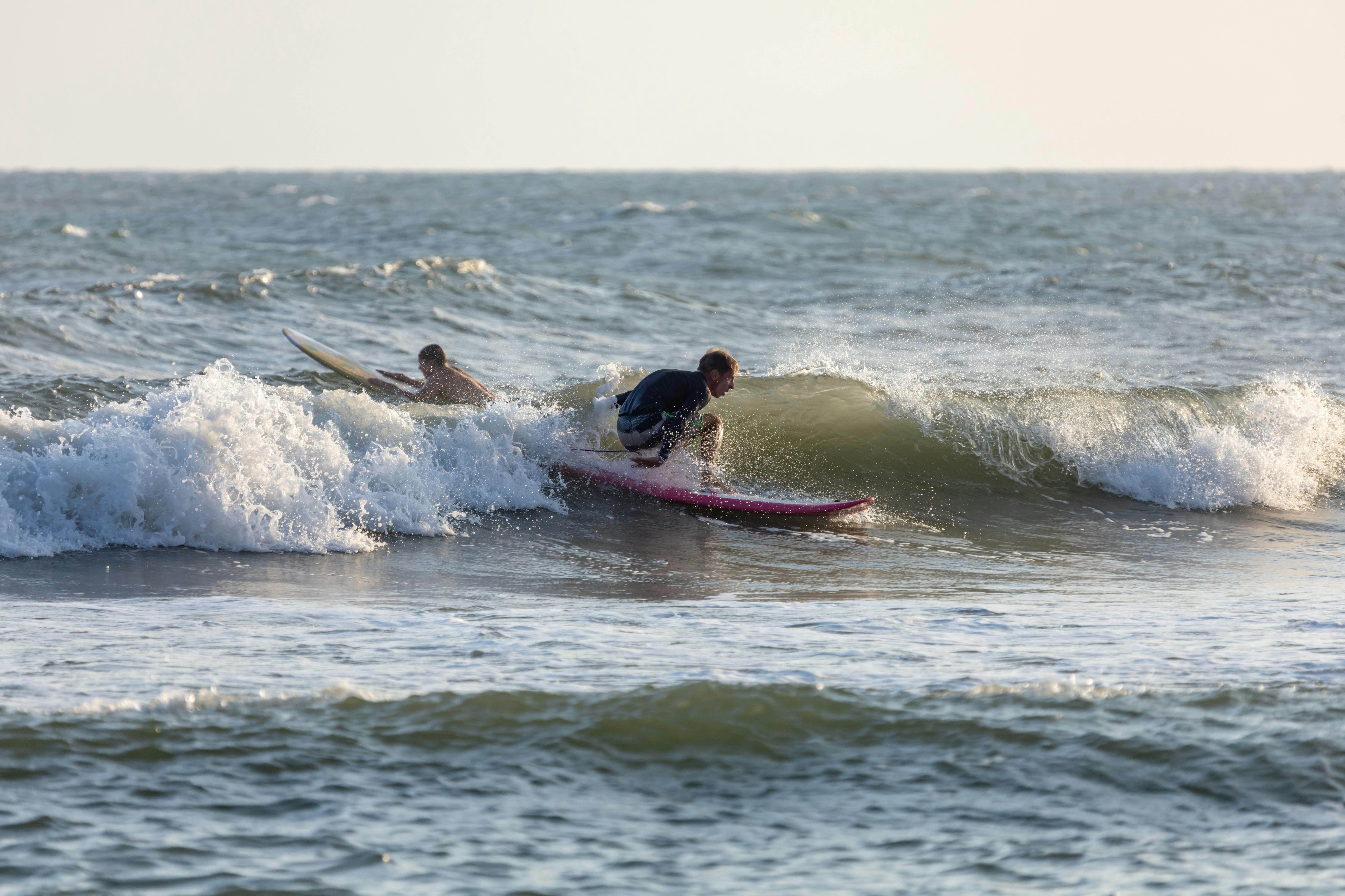 Aerial View of People Surfing on Big Waves · Free Stock Photo