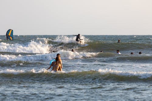 People and Surfers on Sea Waves