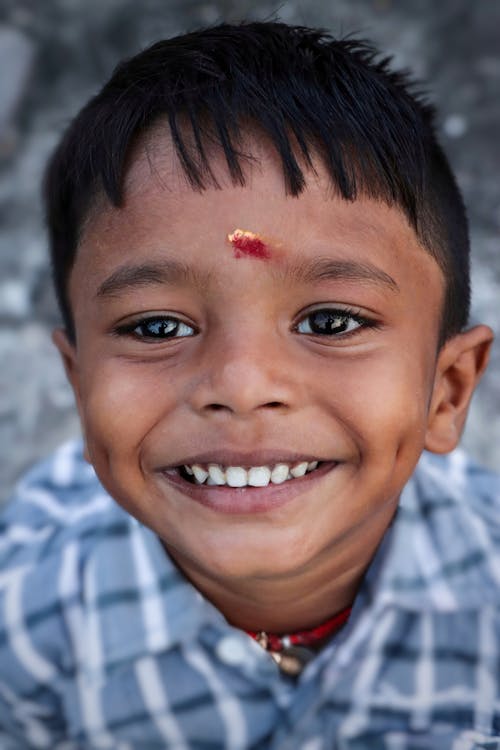 Little Boy with Red Dot on Forehead