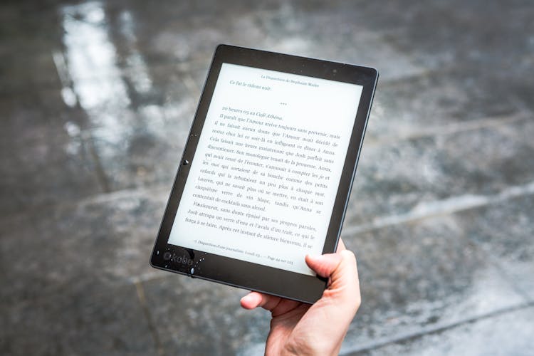 Person Holding Black E-book Reader 