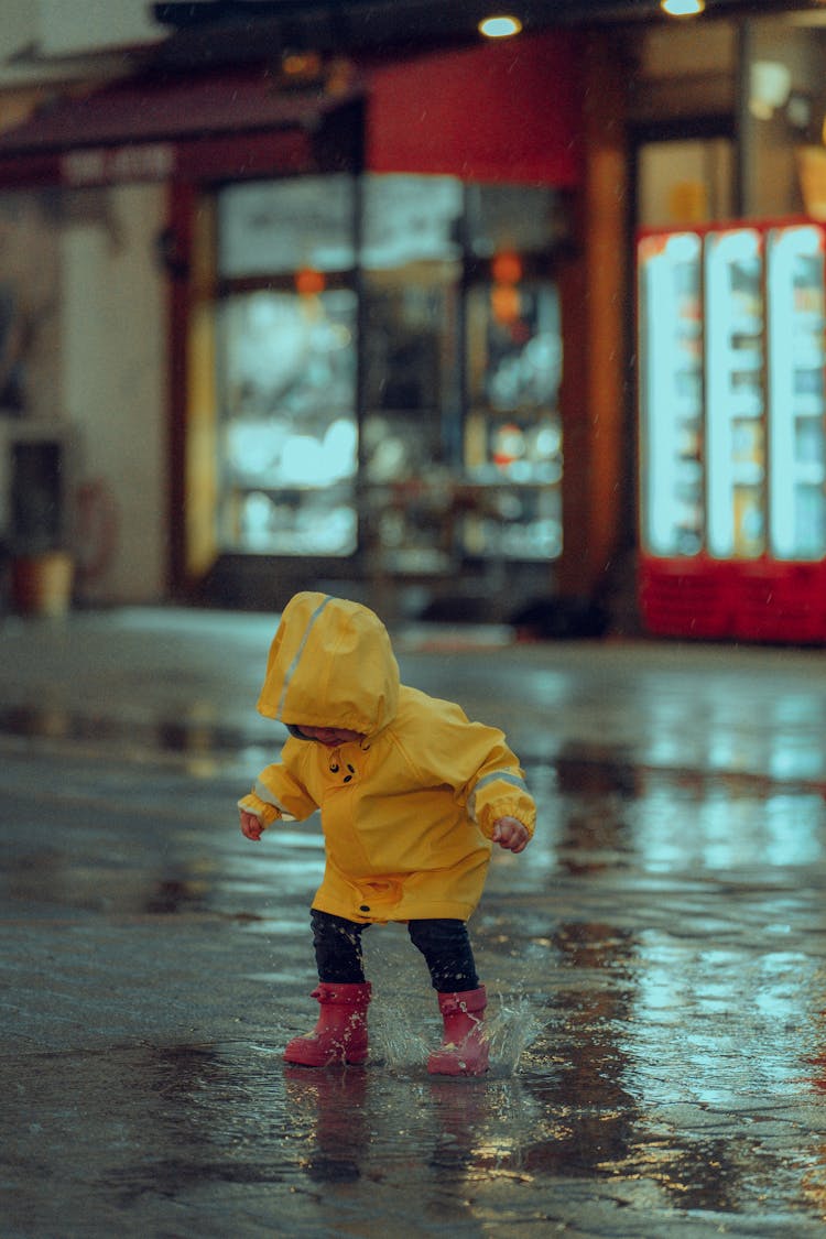 Child Jumping In Puddle