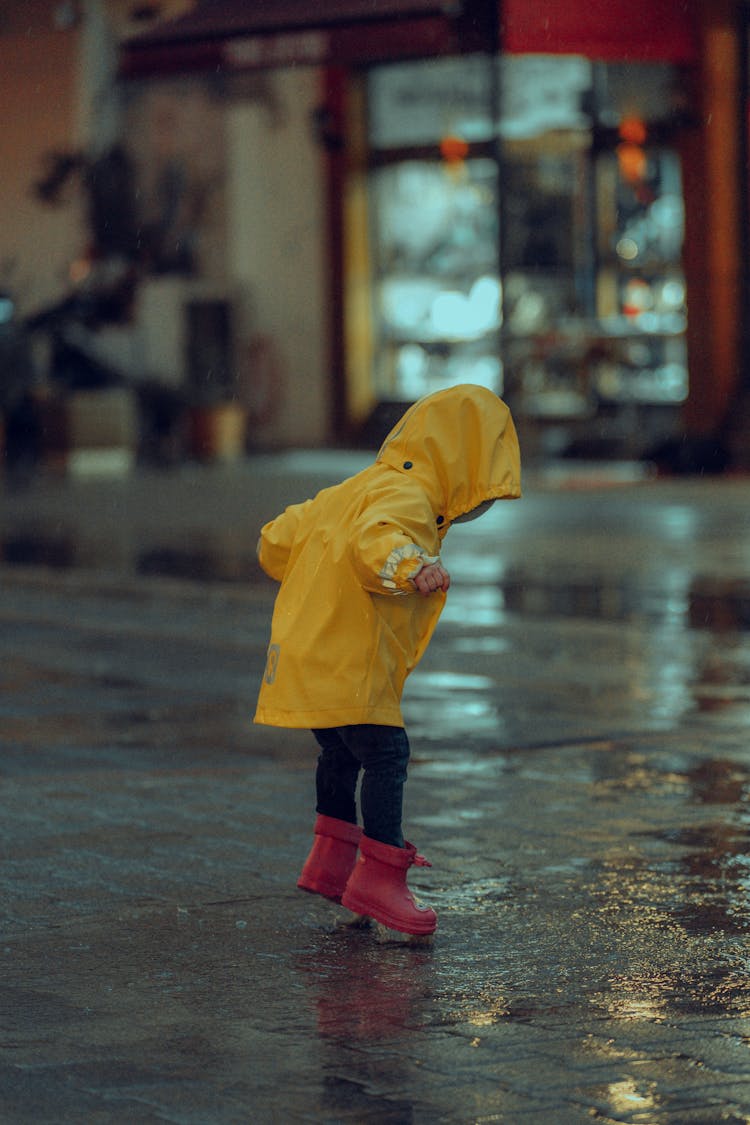 Child Playing In Rain