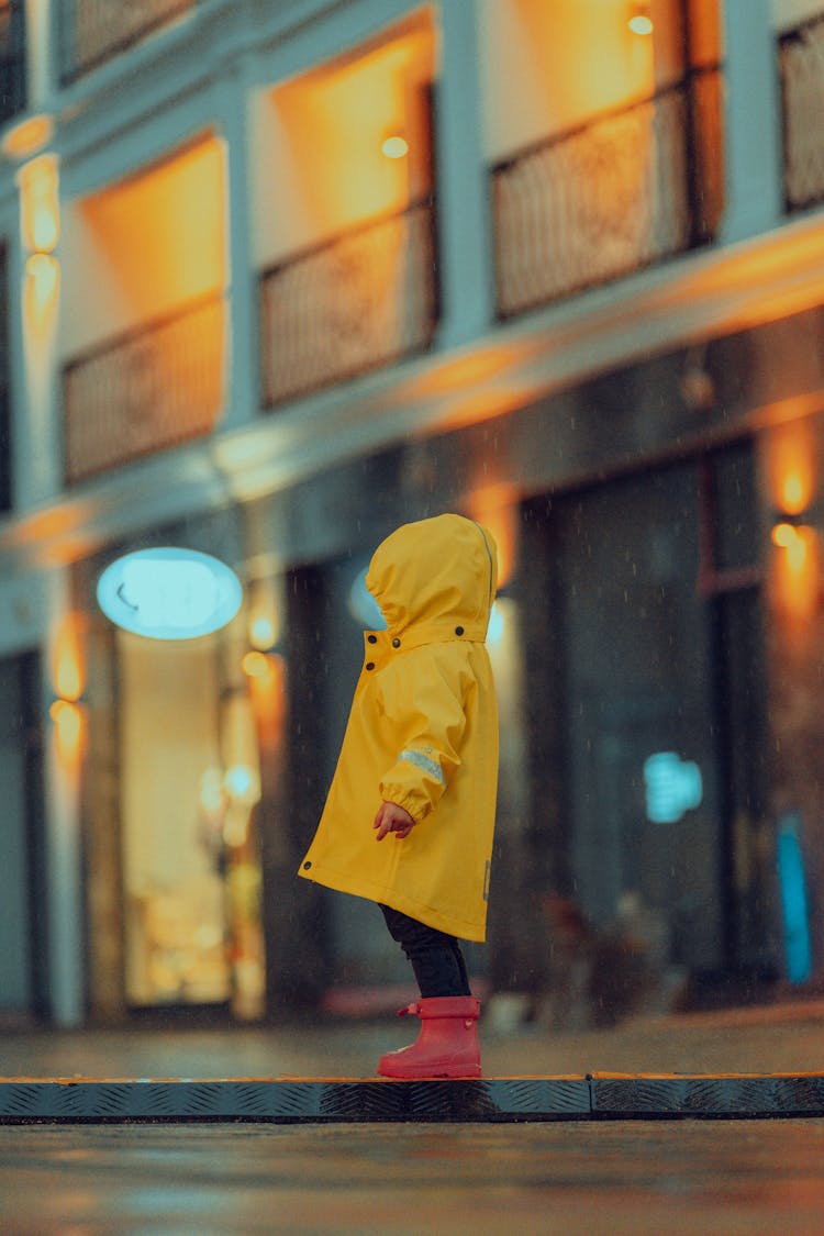 Child Wearing Raincoat In City