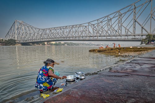Woman Washing Dishes in Hooghly River 
