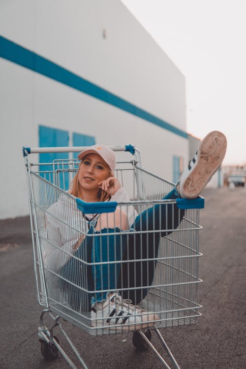 Woman Sitting Inside Grocery Cart