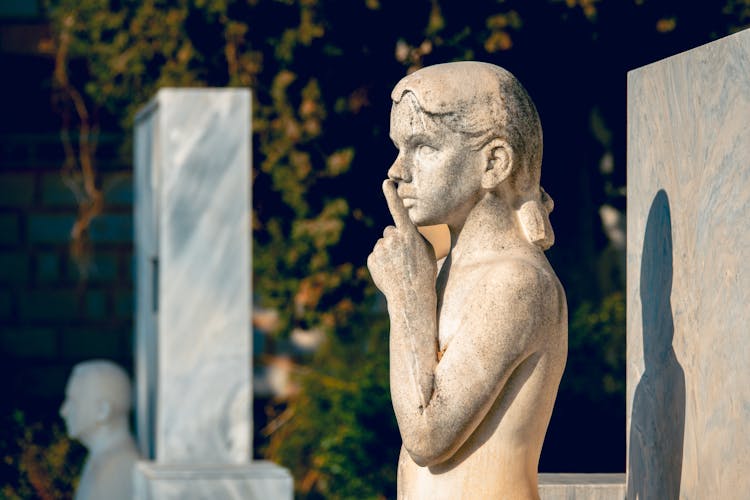 A Sculpture Of A Boy