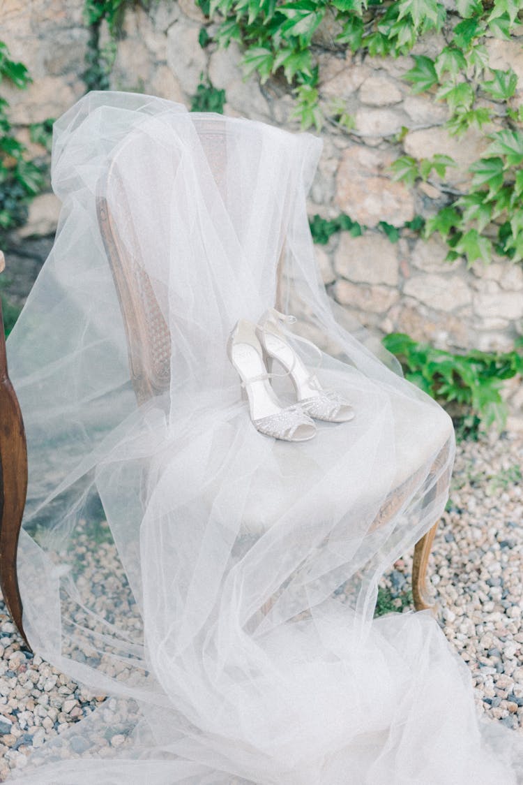 Tulle Wedding Veil And Sandals On Chair