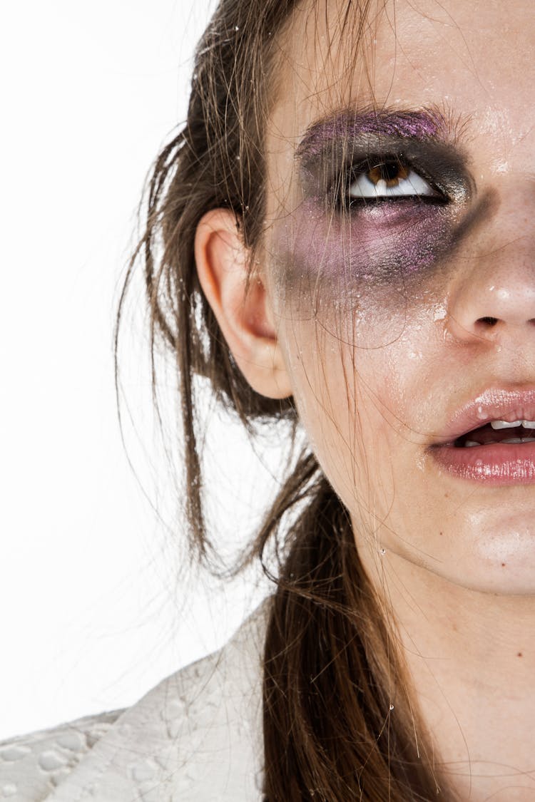 Close-Up Photo Of Woman With Black And Purple Eye Shadow