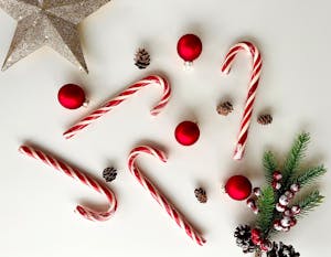 Close-Up Shot of Christmas Ornaments on White Surface
