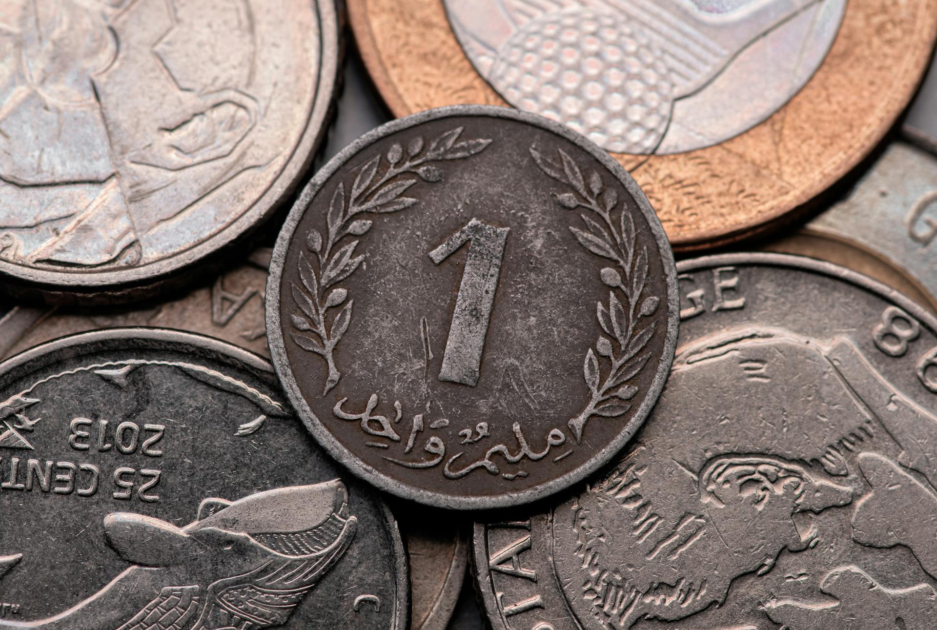 A diverse collection of Tunisian coins showcasing intricate designs and textures in close-up view.