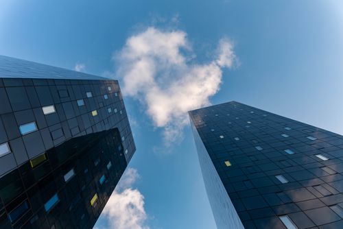 Free Low-angle photo of glass skyscrapers against a cloudy sky, showcasing modern architecture. Stock Photo