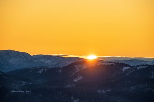 Breathtaking sunset over Trondheim's mountains, capturing nature's serene beauty in Trøndelag, Norway.