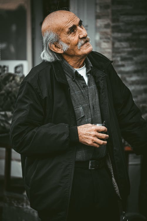 Photo of an Elderly Man Keeping Glass in Hand
