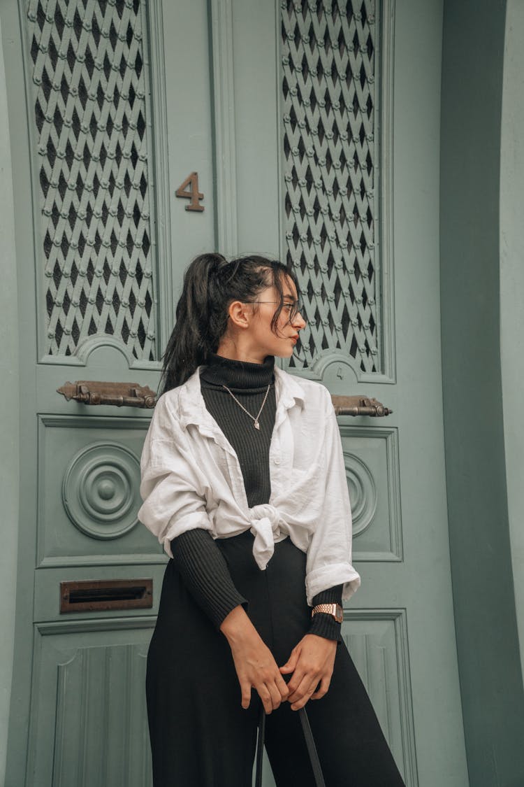 Photo Of A Woman Standing In Front Of A Closed Door