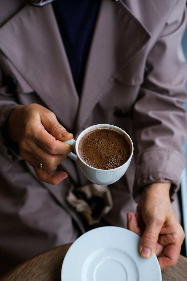 Hands Holding Coffee Cup And Plate