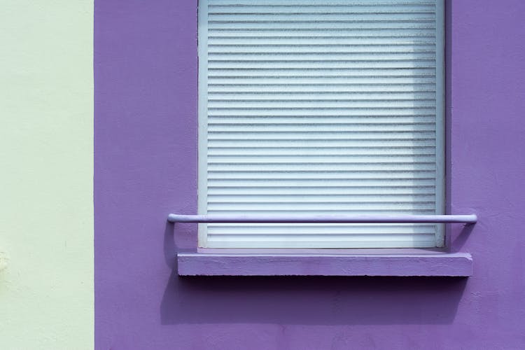 Photo Of A White Shutter And Violet Wall