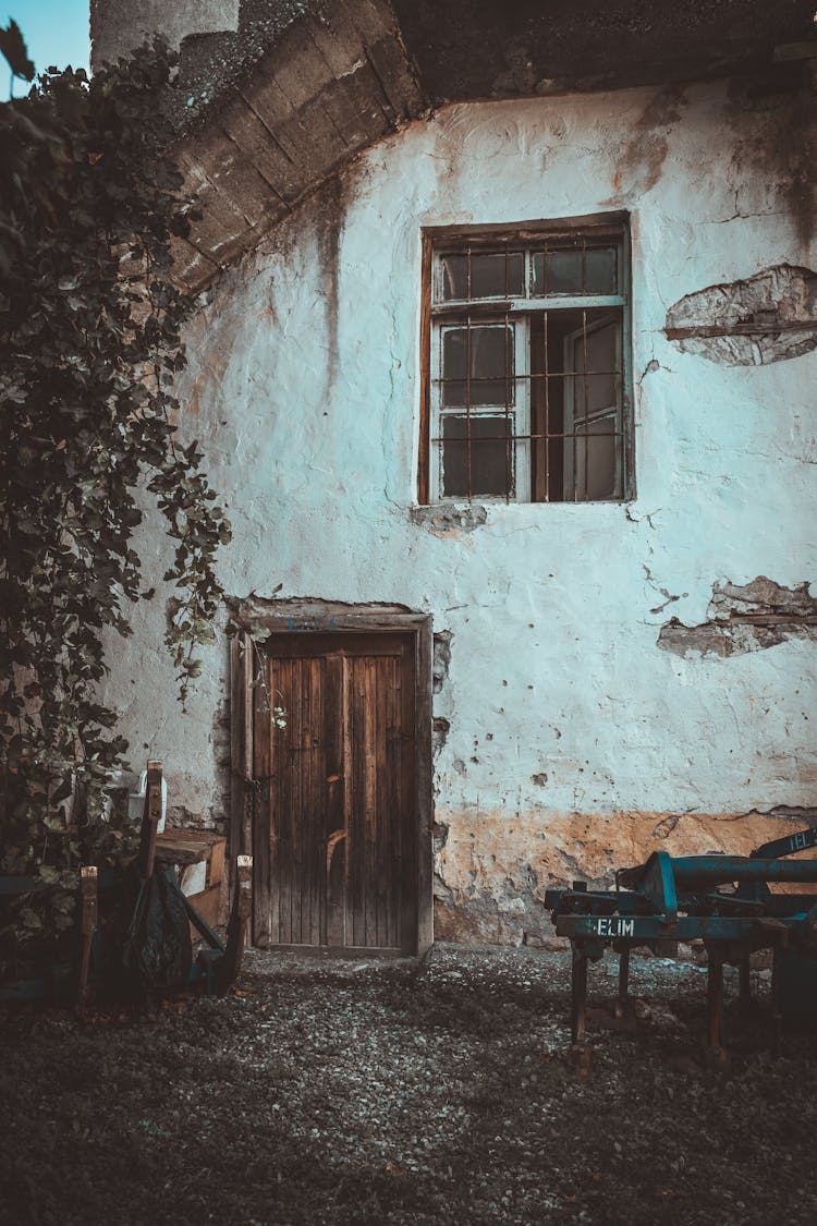 An Abandoned House With A Wooden Door