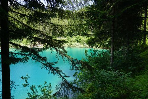 Free Explore the tranquil turquoise lake nestled in the lush forest of Flims, Switzerland. Stock Photo