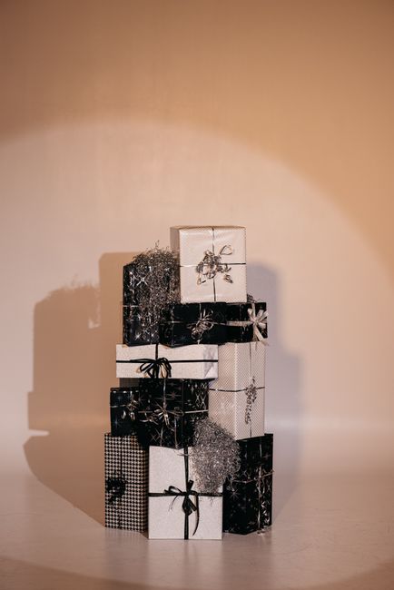 A stack of elegantly wrapped Christmas presents in monochrome style, perfect for holiday decor inspirations.