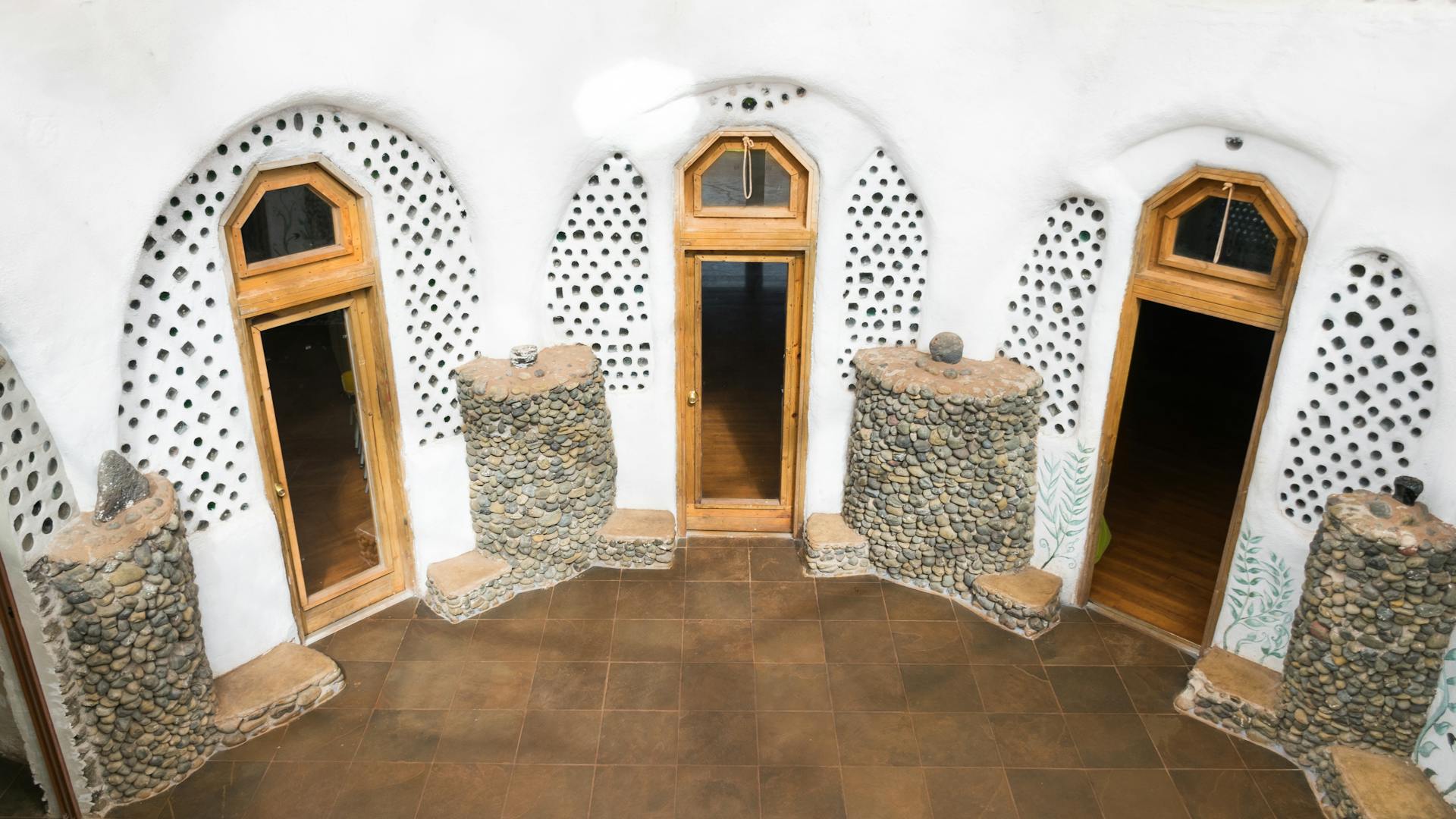 Explore this sustainable earthship interior showcasing natural architecture and eco-friendly design.